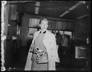 Mrs. Arthur Godfrey standing in airport terminal