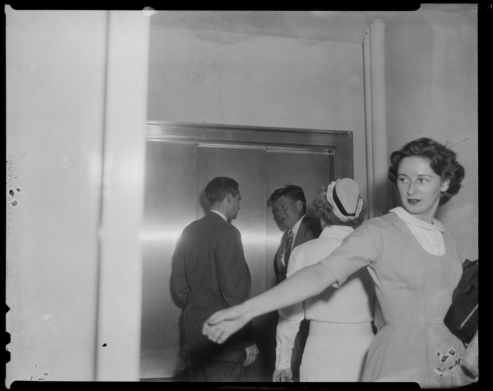 Arthur Godfrey standing by elevator with another man