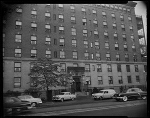 Building exterior with vehicles parked on street