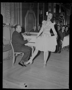 Morton Downey playing the piano with woman dancing next him