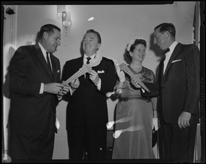 Governor Foster Furcolo, Jack Haley, Kay Furcolo, and Ray Bolger holding prop torches