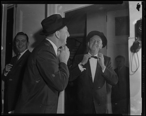 Ray Bolger fixes bowtie in mirror