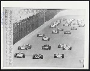 Donohue Jumps To Lead At 500 Start. -- Mark Donohue, in car 66, in the middle of the first row, jumps to the lead at start of the Indianapolis 500-mile speedway race Saturday. Donohue, from Media, Pa., had a first lap time of 166.359 mph to set a first lap record. (Also in first row are Peter Revson, right, and Bobby Unser, left).