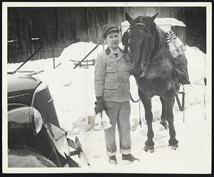 The Milk Must Go Through--Samuel Melling, one of the United Farmers' drivers who were feted last night at a dinner at the Hotel Lenox, demonstrates how he delivered his milk during last week's storm. Unable to get his wagon through the drifts, he unhitched his horse and finished the route pack-saddle style.