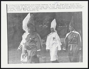 Robed Members of the Ku Klux Klan march here to a meeting at the county courthouse only hours after a civil rights march. Klansmen later dispersed to a ball park where they heard Robert Shelton, Imperial Lord of the United Klans of America say that qualified Negroes should be allowed register to vote.