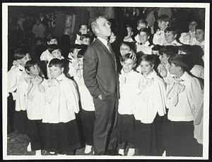 Mayor White puts fatherly hand on the head of one of the members of St. Ann's Boys Choir at Christmas festivities on the Boston Common.