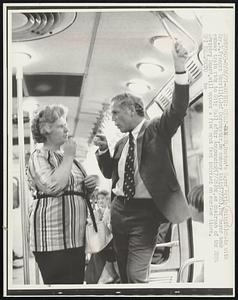 Strap-Hanger, Boston's Mayor Kevin White (R) chats with Mrs. M. Frances Morrill (L) of Dorchester, on subway train (7/26). The mayor took subway train ride to City Hall after announcing (7/26) he, as chairman of the MBTA Advisory Board, will oppose a five cent fare increase on surface lines.