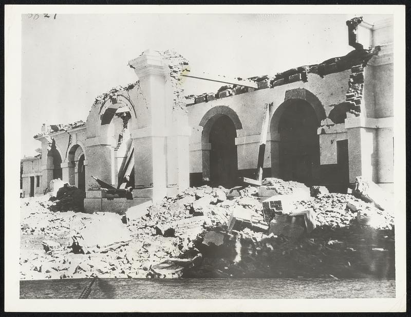 First Photos of the Ruins of the Railway A photograph of the ruins of the railway station at Jamalpur, northern India, were many persons were killed in the earthquake of January 15. This particular view is of the waiting room, part of which collapsed on an incoming train, killing many. Final and unofficial estimates of the dead in India reached 9,000 persons, the property damage running into millions of rupees. This is the first photograph to arrive in this country of the earthquake damage.