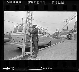 Man climbing pole near Customs House