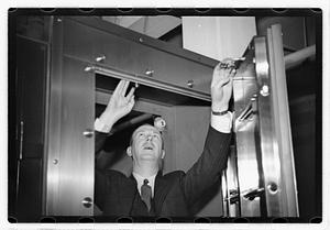 A man demonstrating how to break into a safe