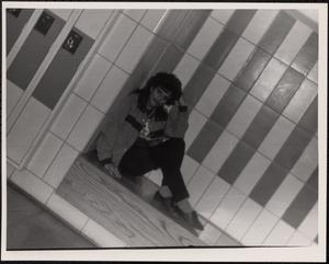 Young woman posing next to lockers
