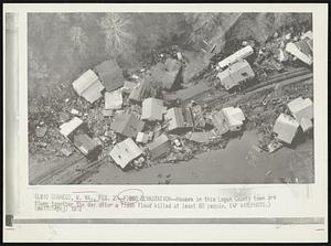 F100D Devastation--Houses in this Logan County town are flung together the day after a flash flood killed at least 60 people.