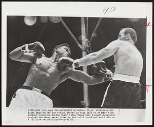 Patterson at Work-- Floyd Patterson, his right hand cocked for action, drives in with left as he mixes with Ingemar Johansson during their title fight here tonight. Johansson dropped the champ seven times in the third round and won title on a TKO.