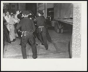 New York,-- Pickets Driven Back by Police -- Police drive pickets back on the sidewalk away from the entrance to the American Machine and Foundry Co. plant in Brooklyn this morning. Pickets had workers attempting to enter the plant where a strike was called 14 weeks ago by the Local 116 of the United Auto Workers, C10.