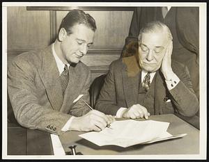 Lou Gehrig, Jake Ruppert. For years, Bath Ruth played the leading role in the Ruppert Spring Follies, which has his contract signing as the plot, while Gehrig portrayed one of the sword bearers in the war scenes. Lou stepped up when Babe stepped down this year and here he is, signing the old prop document for the benefit of the camera man.