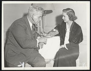 "Lie Detector"--For Hauptmann? With Bruno Hauptmann already agreeing, Governor Hoffman gave his support today to a proposed lie detector test but declared it would first have to be approved by Supreme Court Justice Thomas W. Trenchard. Dr. William Moulton Marston one of the originators of the "Lie detector" who is urging that the test be made, demonstrates the sphygmomanometer on Miss Dorothy Richey. He calls it a "blood pressure" test.
