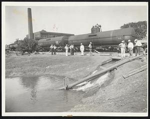 Water by Rail to Relieve Drought. Creston, Ia., always had relied on two lakes for its water supply, but the drought of this summer blotted out the water as well as blistering the crops. The drought division of the federal emergency relief administration has taken over the problem and as its first step is delivering 42 railroad tank cars full of water daily. The water is pumped into one of the lakes and thence through the water system. The water is hauled from Council Bluffs, Ia., 100 miles away. Here is the scene as water was piped into the lake. The water rates have jumped to four times the old rate to meet the added expense.