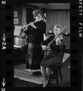 Lea Pearson playing flute and Florence Pearson playing violin