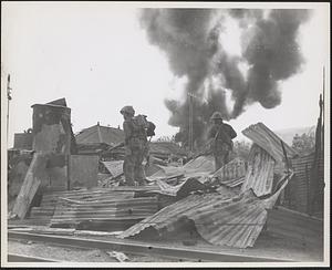 Marines enter the ruins of Garapan