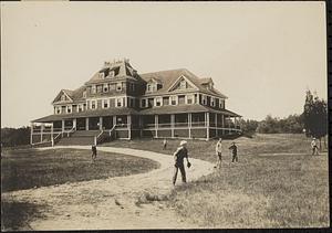 Sea Shore Home seen from the front, boys playing baseball in the foreground