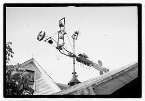 An elaborate device on roof, possibly a weather vane
