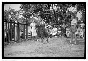 Two young women playing horseshoes