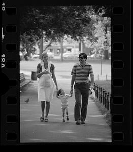 Mom, dad and two children walk in The Common, downtown Boston