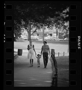 Mom, dad and two children walk in the Common, downtown Boston