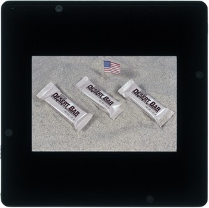 Food lab, desert shield, candy bar on sand with flag