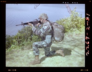 Combat arms div., kneeling position, woodland uniform with Alice + Kevlar helmet