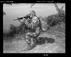 Combat arms div., kneeling position, woodland uniform with Alice + Kevlar helmet