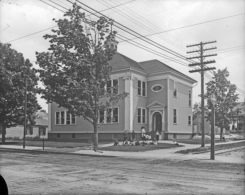 Schoolhouse with kids in front