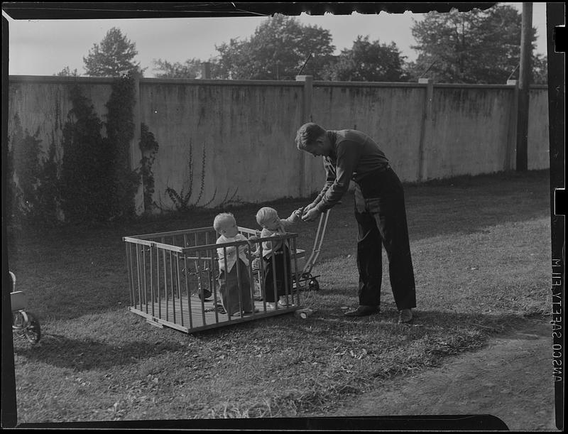 Two children in a playpen