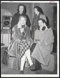 Passengers aboard the New Haven Railroad’s Merchants Limited arrive at South Station about nine hours late. Included are Mrs. Ethel Maunsell of Lynn with her son, Peter, 10, left and George, 12, upper left photo. At lower left are students from Endicott Junior College. They are, back grow, Barbara Schmermond and Susanne Chisholm. In front are Susan Collins and Hope Naylor. Mrs. Frank Kusela holds her daughter, Carol 3, above.