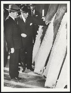 Magnesium Plant in California Will Double U. S. Supply. Sidney Hillman (left), OPM co-director, and Henry J. Kaiser, boss of Permanente, with some of the magnesium produced at the plant, which Kaiser had built in seven months. Workmen carved a great gash in Bald Mountain on Permanente Creek, and literally hurled up a factory.