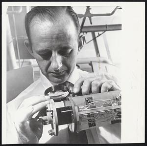 Revolutionary magnet developed by Westinghouse engineers weighs one pound but creates magnetic field twice as strong as that of 20-ton electro magnet.