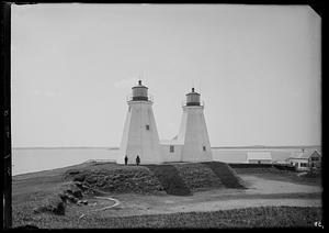 Two people standing in front of lighthouses