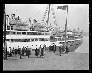 People waving to an unidentified ship