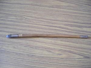 Baton with metal tip that incorporates a bullet