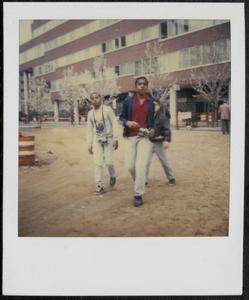 Three boys walking with cameras