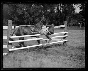 Rider getting off of a horse