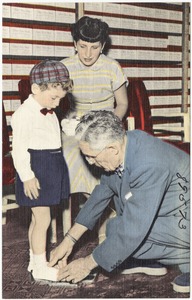View of store clerk measuring a child's foot