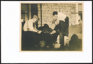 Shucking sea scallops, Morris Johnson, Austin Johnson (Uncle of Morris), Mary K. Johnson at home of Abby K. Johnson, mother of Morris Johnson, Rte., 28, West Yarmouth, Mass.