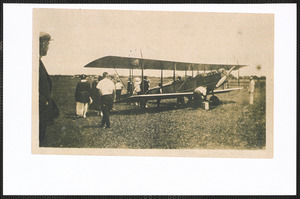 Airplane with people standing on a field, West Yarmouth, Mass.