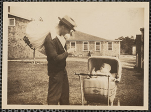 Unidentified man with infant in stroller