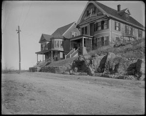 Two houses with an outcrop of rock in front