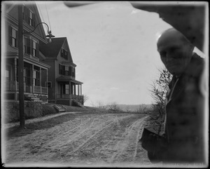 Dirt road with houses to one side