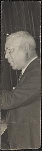 Man in suit and tie with glasses in profile