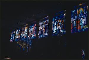 Row of stained glass windows with Christian imagery