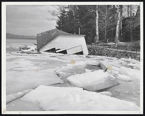 Ice Squeeze boat house owned by Edward Dwyer badly damaged when high winds shifted ice Sunapee, N. H. Heavy rains in recent weeks lifted the high water mark in the lake inches above normal causing estimated damage at $15000 to $20,000 to boathouse piers.
